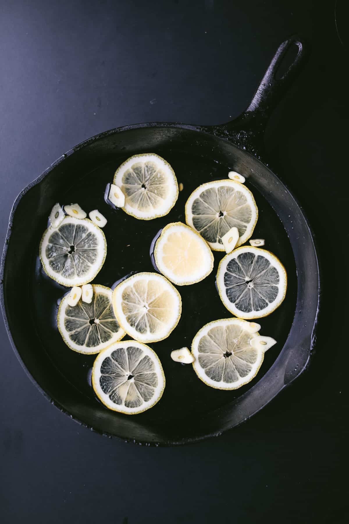 lemon and garlic in a cast iron pan