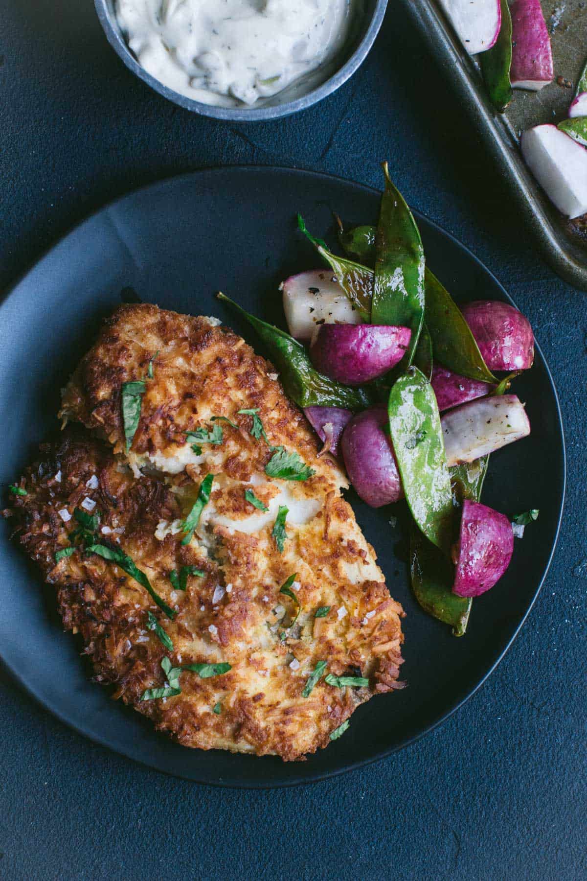 Keto Coconut Crusted Fish with Snap Peas and Radishes.